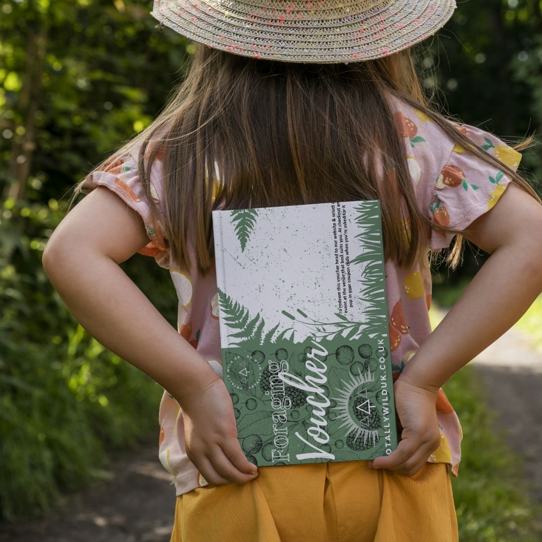 child holding a foraging voucher