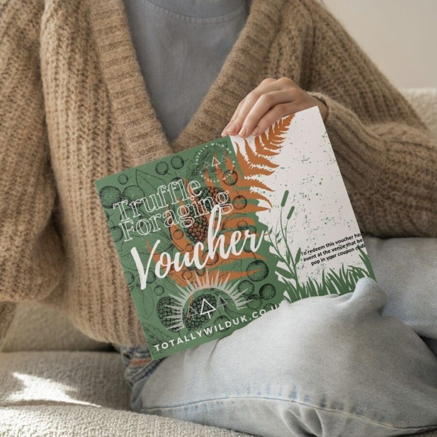 lady holding foraging voucher in front of them with jumper