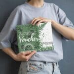 lady holding foraging voucher in front of them